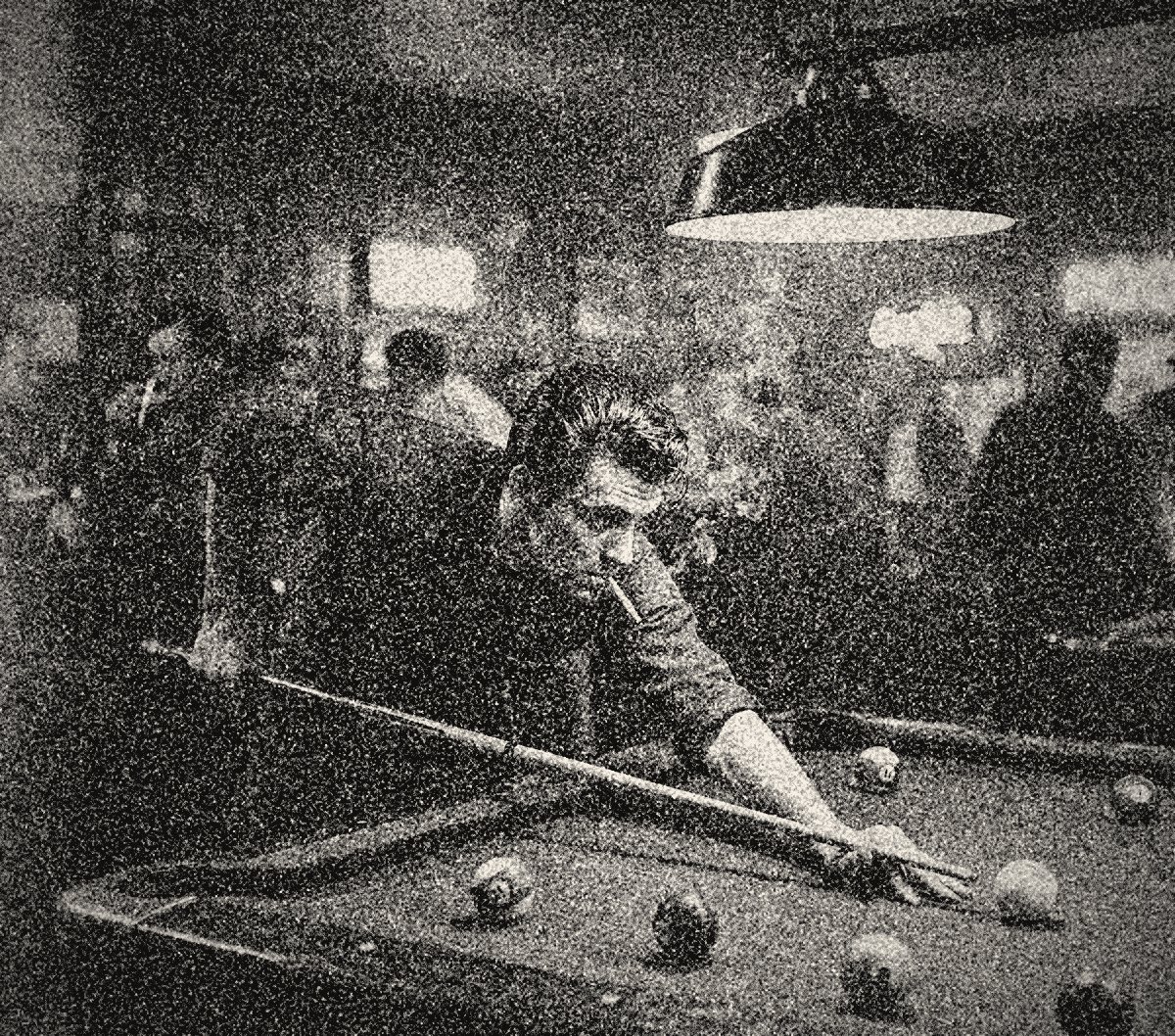 Grainy black and white 1965 photograph of a young Sal Marino leaning low over a pool table to line up a shot, cigarette in his mouth